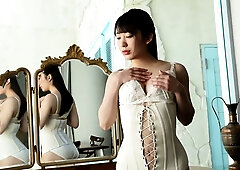 Mizuki Yayoi poses in a white lace corset for a sensual solo session