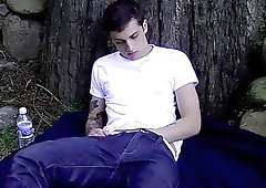 Tattooed twink plays with his cock solo