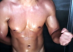 Muscular boyfriend flexes and submits under your gaze in the shower
