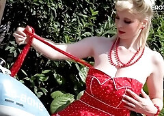 German blonde camgirl Casey Deluxe showcases her big natural tits on a motorcycle for EroticOnly!