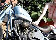 German blonde camgirl Casey Deluxe showcases her big natural tits on a motorcycle for EroticOnly!