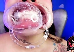 Inked Babe in Ring Gag Drools on Huge Dildo