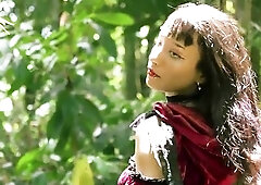 Little Red Riding Hood walking alone in the forest