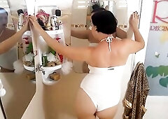 Valuable lady in the shower room rubs cosmetic massage lotion oil on her gorgeous legs. livecam 1-two