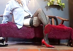 Marvelous teacher sitting on a large sofa wearing mesh tights on her feet, high heels, showing her natural titties whilst crossing her legs and lettin