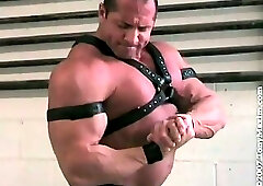 Tony Maxim Flexing and Posing Wearing A Leather Harness And Armbands