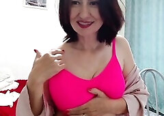 Beautiful Milf makes pleasant circular movements of her tits and this raises her clitoris, pussy becomes wet and panties too