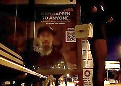 Crossdresser waiting for bus in short dress at night