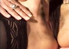 A sultry brunette hair mother I'd like to fuck lounges seductively on the couch in ebony lace underware and sheer nylons, her body aching for int