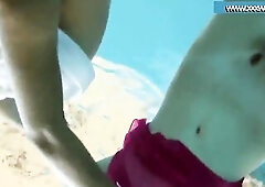 A hot pair swimming in the pool and enjoying eachother