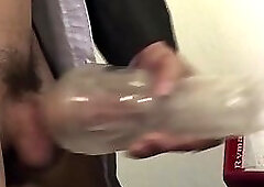 Office stud tugging with fleshlight at desk