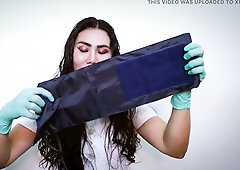 Submissive woman in green latex gloves performs an ASMR medical ritual