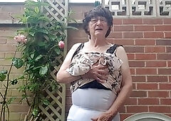 Mature babe Betty Spanxxx shows off her lingerie and girdle in the great outdoors