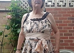 Mature babe Betty Spanxxx shows off her lingerie and girdle in the great outdoors