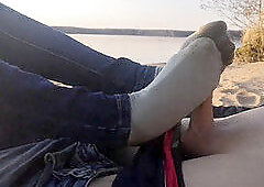 public footjob and socksjob on the beach