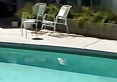 Studs fool around in an outdoor pool and enjoy handjobs