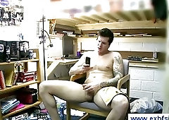 Guy masturbating while looking at porn magazine