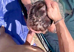 Folks pound rock-hard in front of a married duo on a public beach