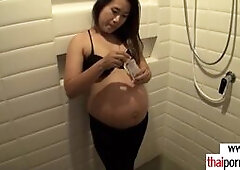 Hot amateur Thai pregnant Pat with big boobs is taking a shower and oiling her sexy body then she has to take care of her horny european lovers big wh