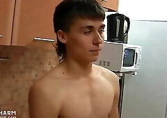 Toned twink peels off red pants for some stroking