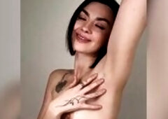 Bare melons crammed taut beneath her arm ?