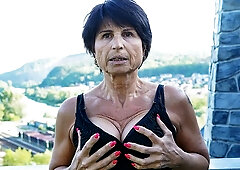 Big-boobed brunette Petra T nicely plays with her shaved pussy