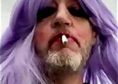 Crossdresser wearing purple wig smokes a cigarette Pov
