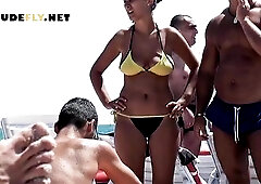 Voyeur beach nudist cutie getting suntanned among bikini cuties