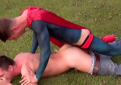 Guy in superhero latex costume ass fucks amateur guy in outdoor scenes