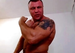 Athletic hairy muscle bear flexing for the camera in various poses