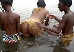 Raw documentary footages with three Afro tribe gals dancing in the river in the forrest