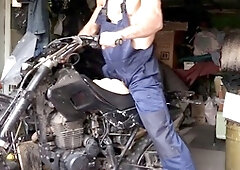 Horny Russian mechanic gets aroused while fixing a motorcycle in the garage and has steamy fun with a silicone ass