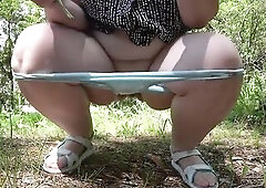 A bulky grandma with a full bladder in the park wanted to void urine. That Babe lifts her suit, takes off her pants, squats down and pisses. Golden sh